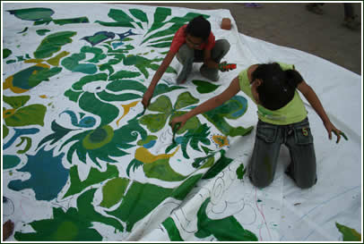 School girls painting the massive border tarps at HB Kapadia School.