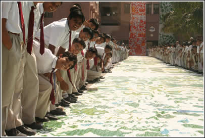 Kids line up at the sides of the massive border pieces - each measuring 348 feet (106 meters) long 