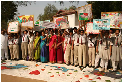 Students and teachers display friendship signs that they made for the occasion.