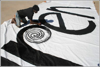 Boy from Born Free Art School paints on The World's Largest Love Letter. 