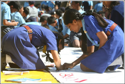 School children sign the letter.