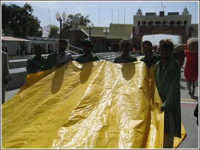 The porters are eager to help with The Golden Bridge inside Wagah Border, in what's known as "No Man's Land." 