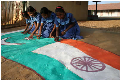 One of the many small classrooms in Girls in a kutchy school color the dirt with Indian and Pakistani flags in honor of our expected arrival.