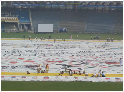 The gift of the World's Largest Love Letter is presented to the kids in Pakistan at Gaddafi Cricket Stadium in Lahore. 