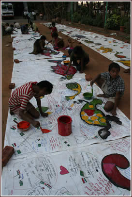 At Allana High School street kids help paint the border tarps too.