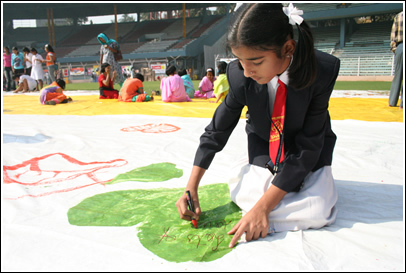 Girl writes a friendship message on a heart during the event. 